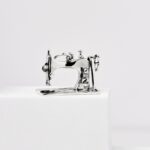 a small silver sewing machine