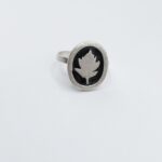 a silver ring with a leaf on it