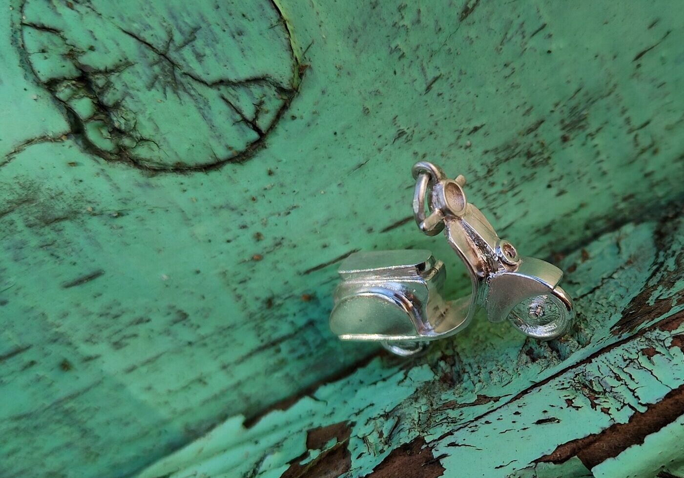 a silver metal object on a green surface