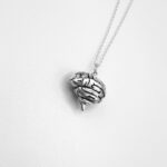 a silver necklace with a brain pendant