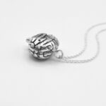 a silver necklace with a brain shape