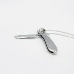 a silver razor on a white background