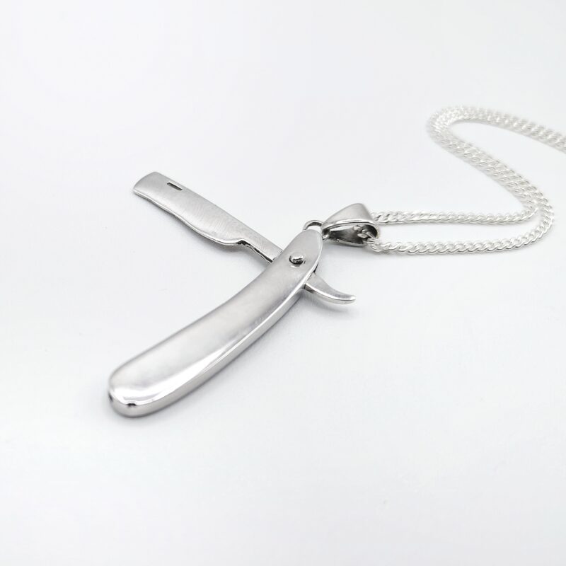 a silver razor on a chain