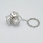 a key chain with a camera shaped object