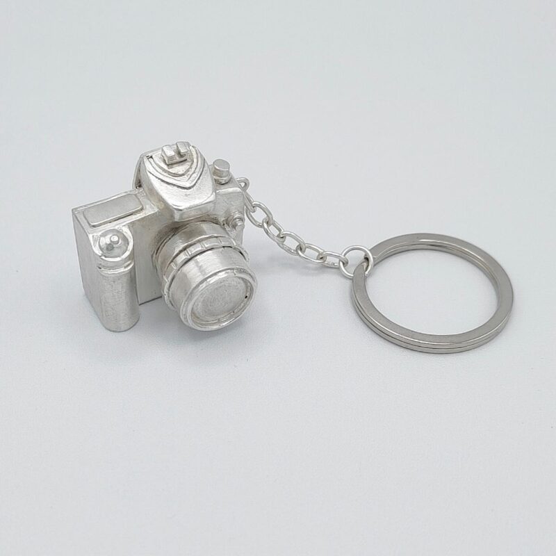 a key chain with a camera shaped object