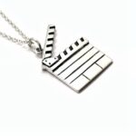 a silver necklace with a clapper board