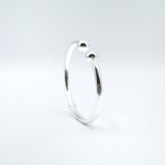 a silver ring with a white background