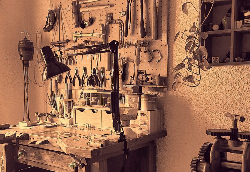 a workbench with tools on the wall